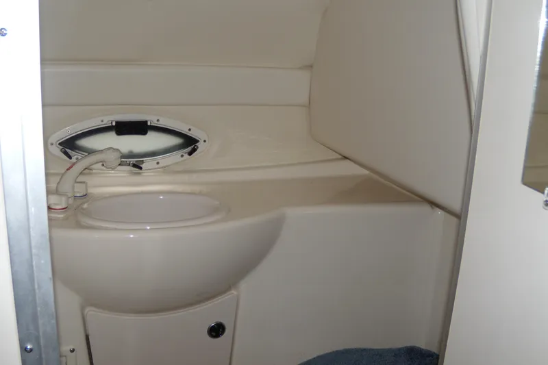 Slide: The Image of 2002 Bayliner 2455 Ciera boat bathroom with sink and porthole window. - 14