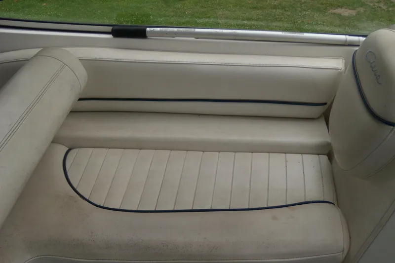 Slide: The Image of 2002 Bayliner 2455 Ciera boat interior with cream leather seating and blue accents. - 9
