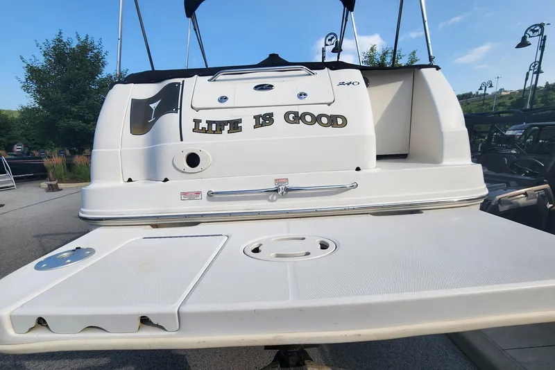 Slide: The Image of 2003 Sea Ray 240 Sundancer boat with "Life is Good" text on the stern. - 6
