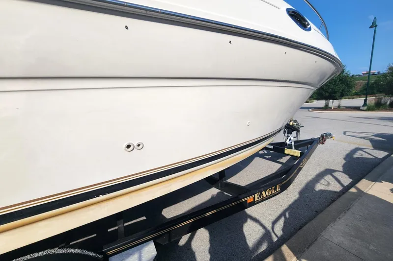 Slide: The Image of 2003 Sea Ray 240 Sundancer boat on trailer in parking lot, side view. - 13