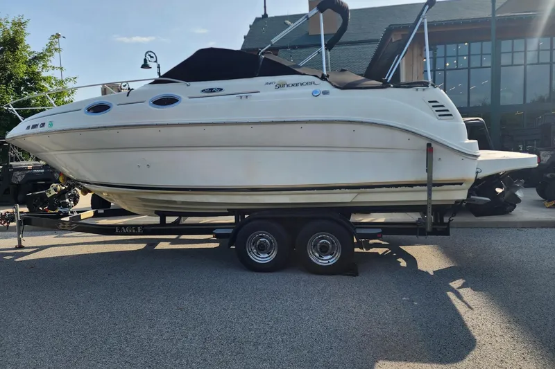 Slide: The Image of 2003 Sea Ray 240 Sundancer boat on trailer, parked outdoors. - 1