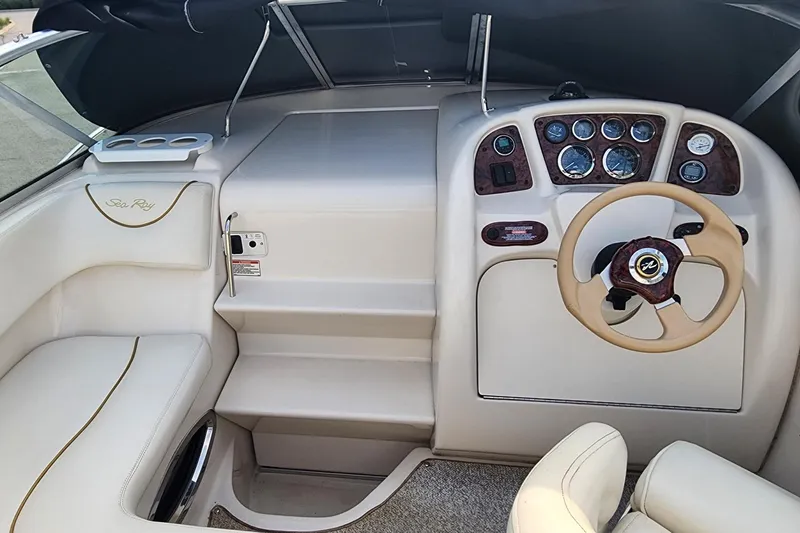Slide: The Image of Interior view of a 2003 Sea Ray 240 Sundancer boat cockpit with steering wheel and dashboard. - 15