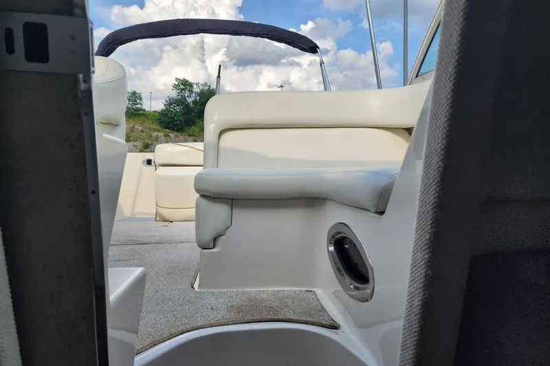 Slide: The Image of Interior view of a 2003 Sea Ray 240 Sundancer boat with white seating and canopy. - 14