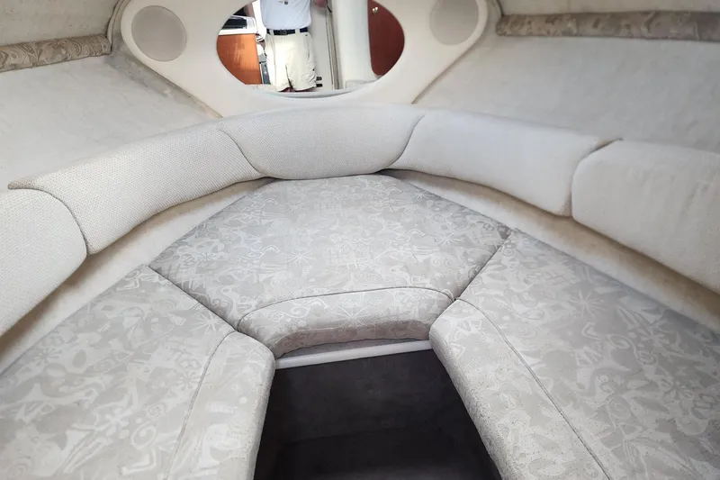 Slide: The Image of Interior cabin of 2003 Sea Ray 240 Sundancer with cushioned seating and neutral tones. - 21