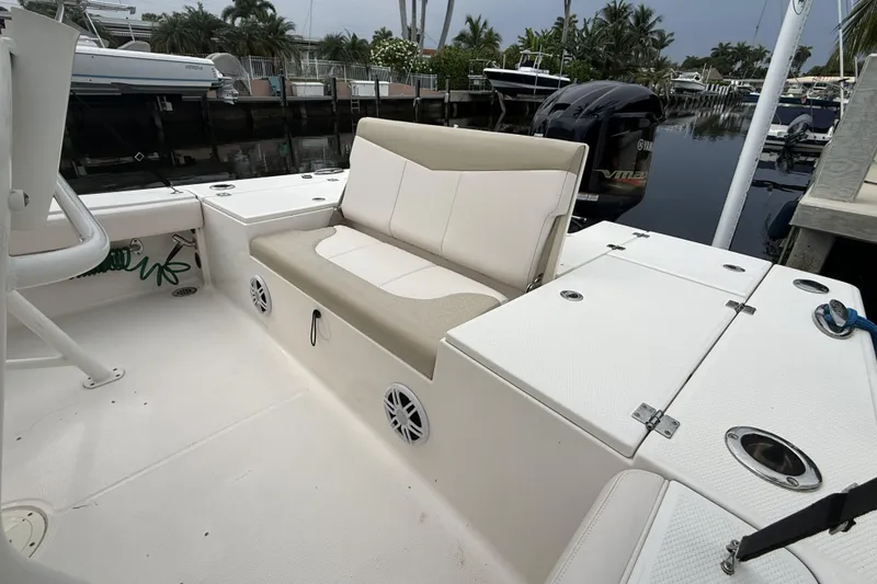 Slide: The Image of 2016 Robalo 246 Cayman boat interior with seating and storage compartments. - 13