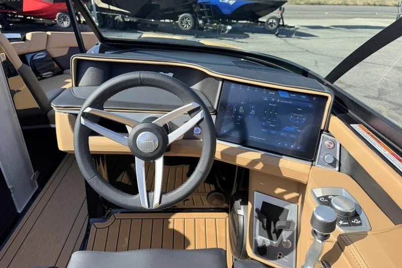 Slide: The Image of 2026 MasterCraft XT23 boat dashboard with modern steering and touchscreen controls. - 12