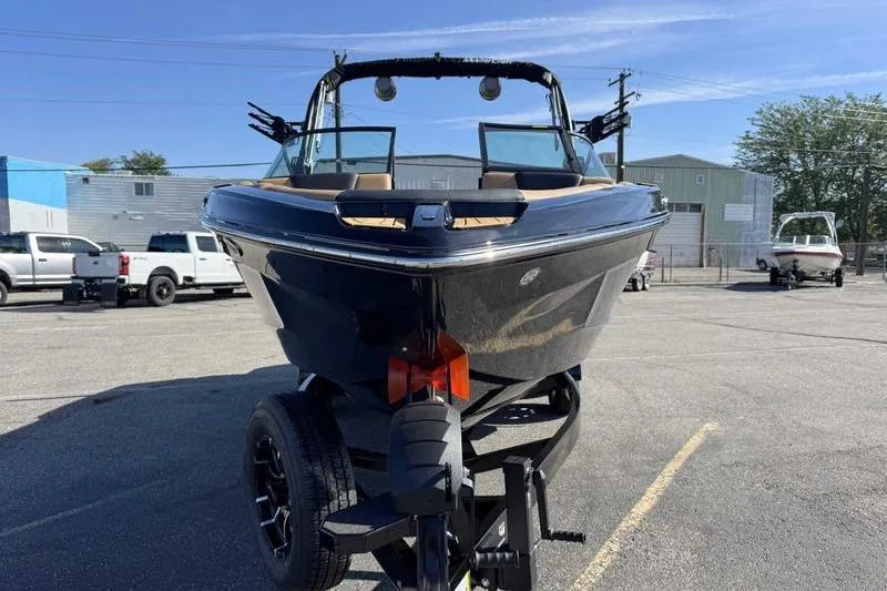 Slide: The Image of 2026 MasterCraft XT23 boat on trailer in parking lot, front view. - 5