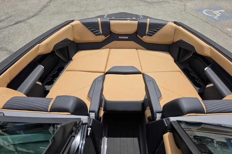 Slide: The Image of 2027 MasterCraft X23 boat interior with tan and black seating, showcasing luxury design. - 5