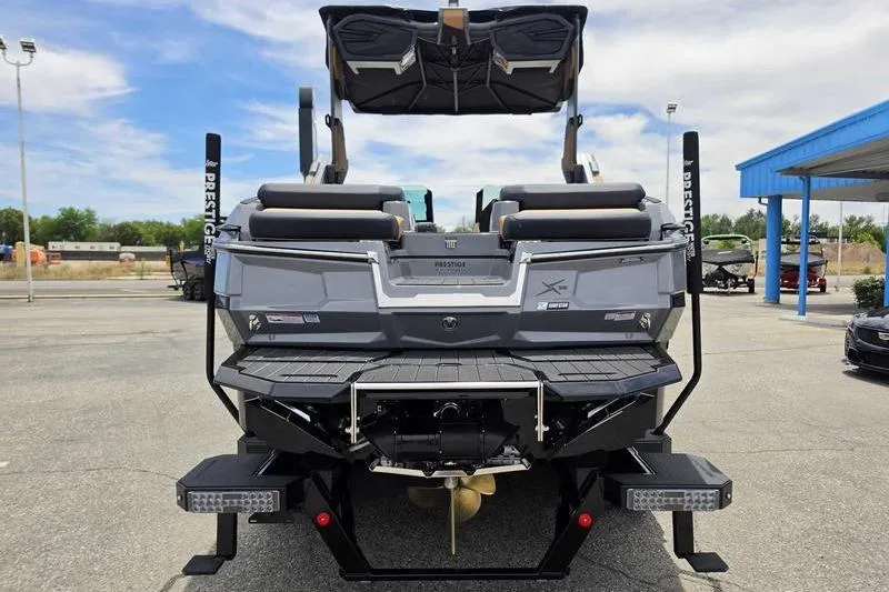 Slide: The Image of Rear view of a 2027 MasterCraft X23 boat, showcasing sleek design and modern features. - 14