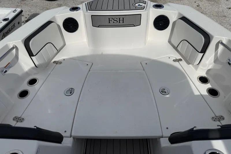 Slide: The Image of 2024 Yamaha Boats 222 FSH Sport E interior with seating and storage compartments. - 8