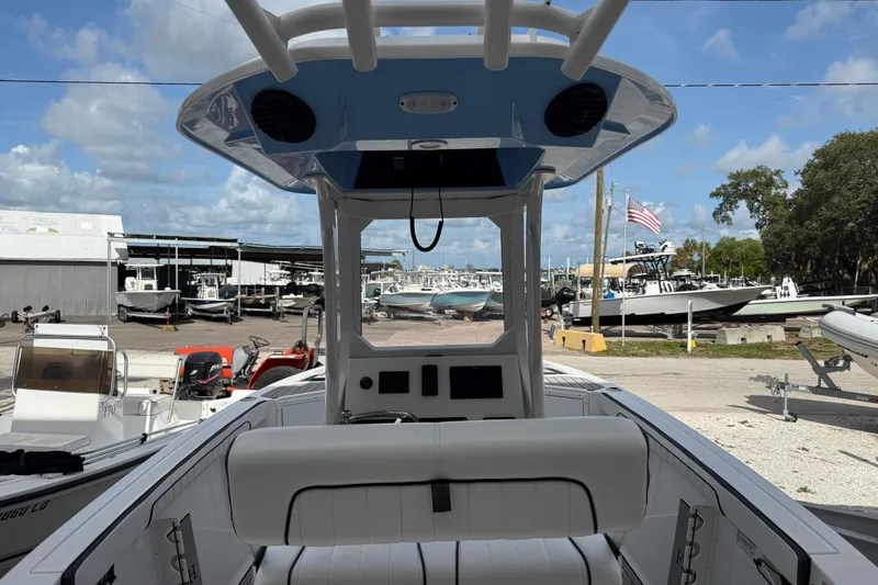 Slide: The Image of 2024 Yamaha Boats 222 FSH Sport E interior view at a marina. - 5