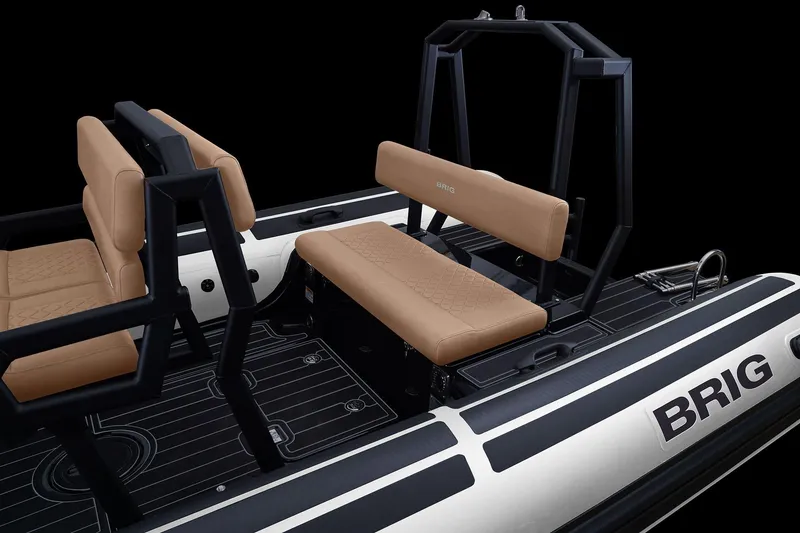 Slide: The Image of 2027 Brig Navigator 20 boat interior with tan seating and sleek black frame design. - 5