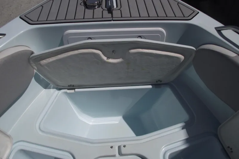 Slide: The Image of Open storage compartment on 2018 Caravell Key Largo 2486WI boat, showcasing interior space. - 8