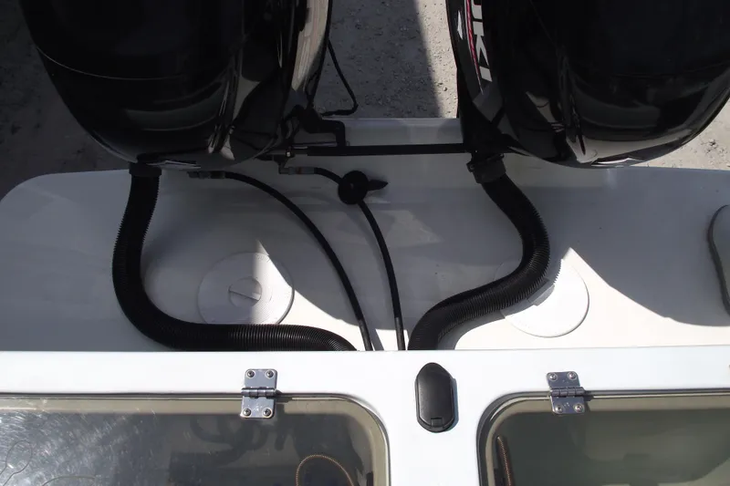 Slide: The Image of 2018 Caravell Key Largo 2486WI boat engine compartment with dual motors and wiring. - 25