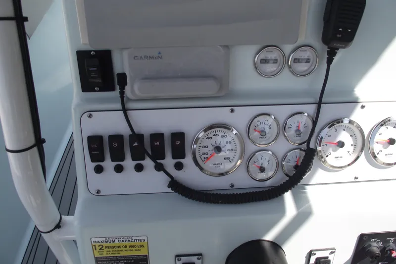 Slide: The Image of Dashboard of 2018 Caravell Key Largo 2486WI boat with gauges and controls. - 20