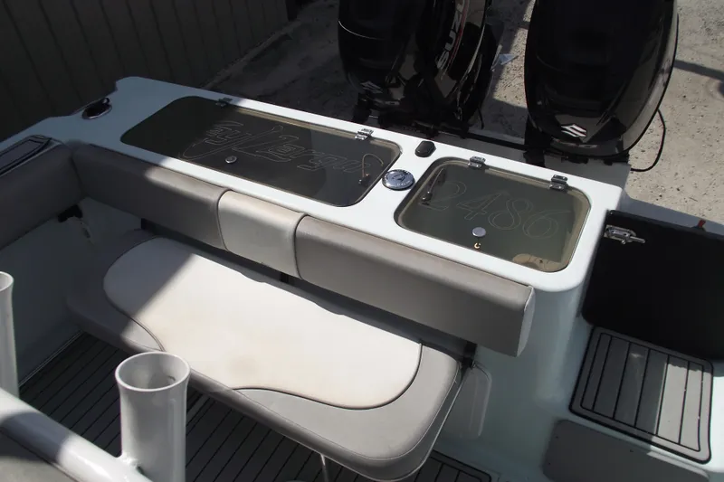 Slide: The Image of 2018 Caravell Key Largo 2486WI boat interior with seating and storage compartments. - 18