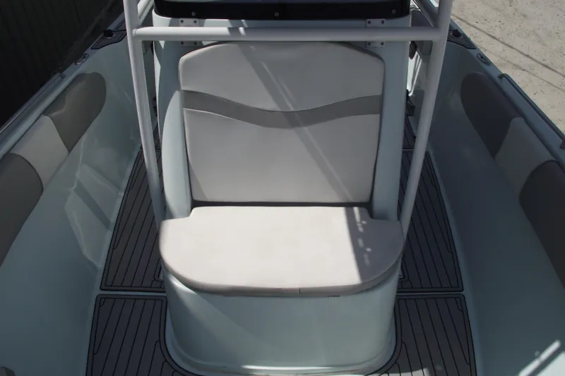 Slide: The Image of 2018 Caravell Key Largo 2486WI boat interior with cushioned seating and sleek design. - 12
