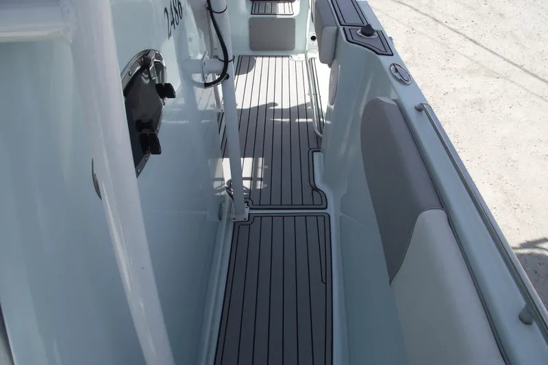 Slide: The Image of 2018 Caravell Key Largo 2486WI boat interior with sleek deck design and seating. - 15