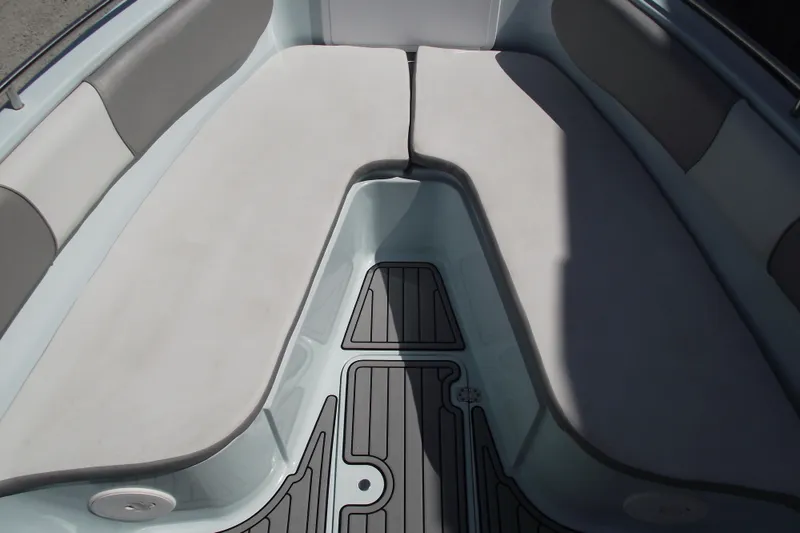 Slide: The Image of 2018 Caravell Key Largo 2486WI boat interior with cushioned seating and non-slip flooring. - 5