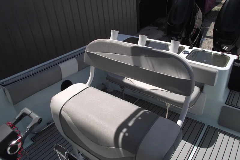 Slide: The Image of 2018 Caravell Key Largo 2486WI boat interior with seating and controls. - 17
