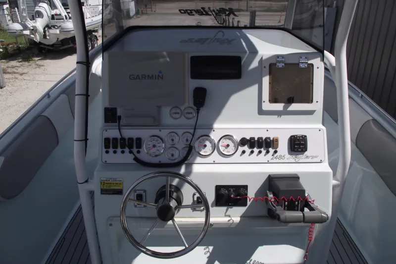 Slide: The Image of 2018 Caravell Key Largo 2486WI boat dashboard with Garmin navigation system. - 19