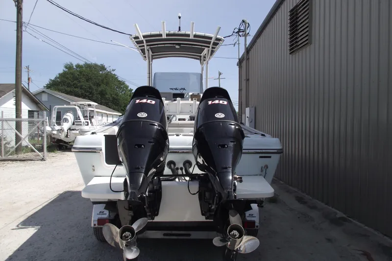 Slide: The Image of 2018 Caravell Key Largo 2486WI boat with dual 140 horsepower outboard engines. - 3