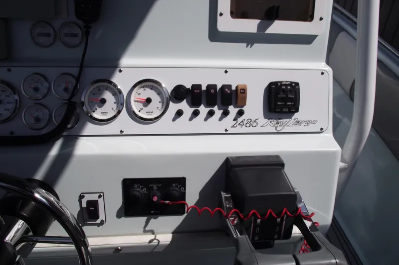 Slide: The Image of 2018 Caravell Key Largo 2486WI boat dashboard with gauges and controls. - 21