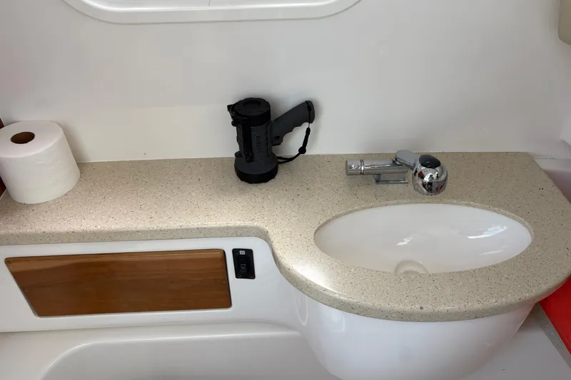 Slide: The Image of Interior of 2015 Belzona 32 Center Console boat with sink and countertop accessories. - 7