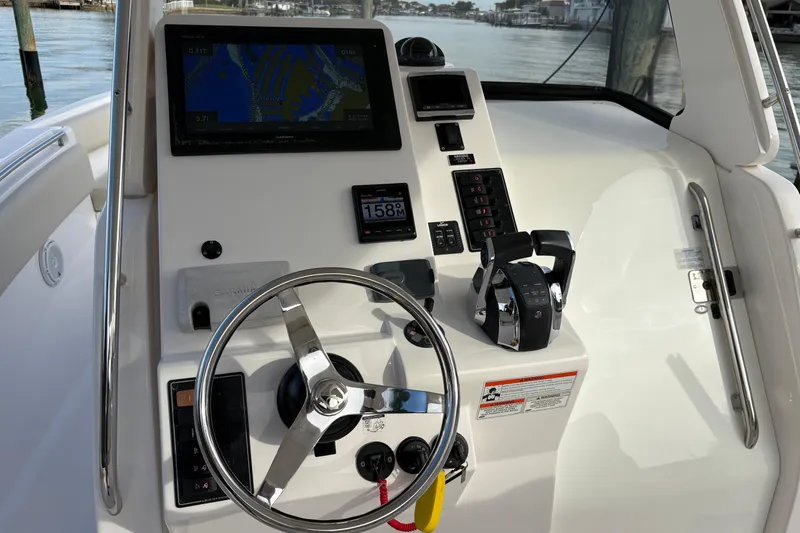 Slide: The Image of Helm of 2015 Belzona 32 Cuddy boat with navigation controls and steering wheel. - 5