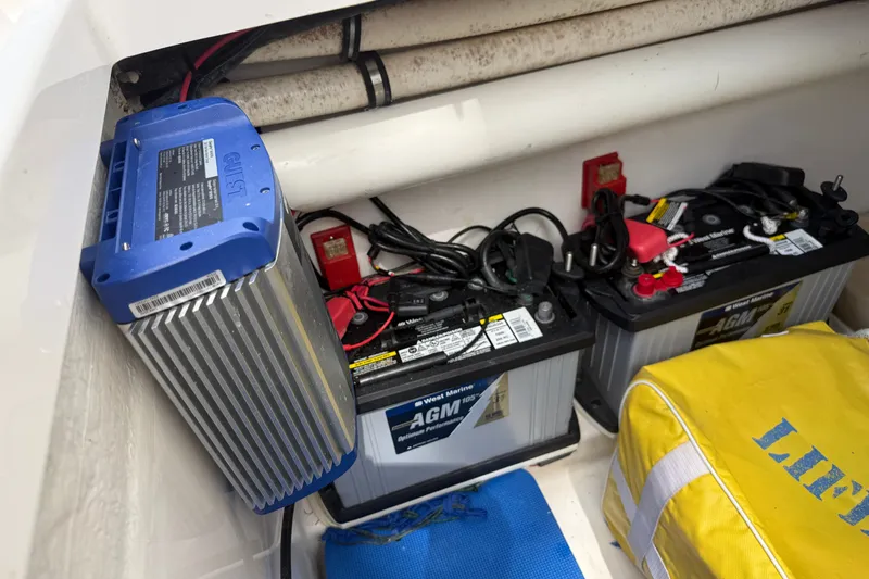 Slide: The Image of 2015 Belzona 32 Center Console boat battery compartment with AGM batteries and charger. - 22