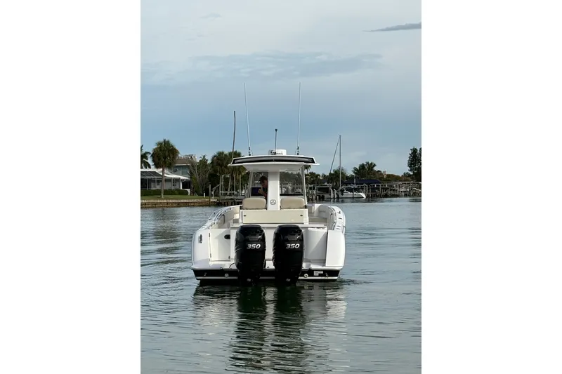 Slide: The Image of 2015 Belzona 32 Cuddy boat with dual 350 engines on calm water. - 2