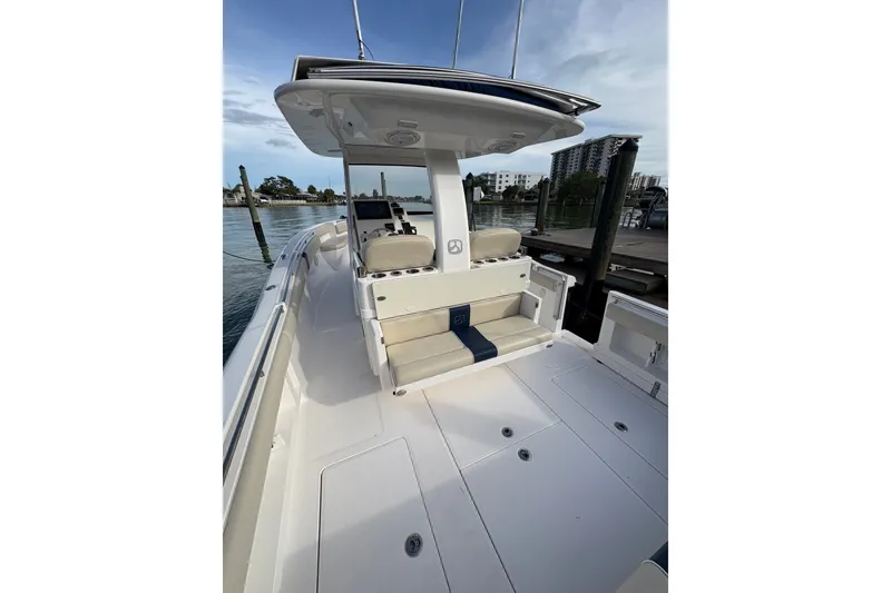 Slide: The Image of 2015 Belzona 32 Center Console boat docked, featuring spacious seating and sleek design. - 21