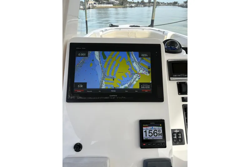 Slide: The Image of Garmin navigation system on 2015 Belzona 32 Cuddy boat, displaying nautical map. - 10
