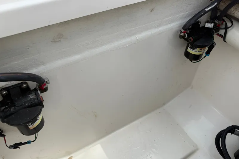 Slide: The Image of 2015 Belzona 32 Center Console boat interior with visible fuel filters and hoses. - 27