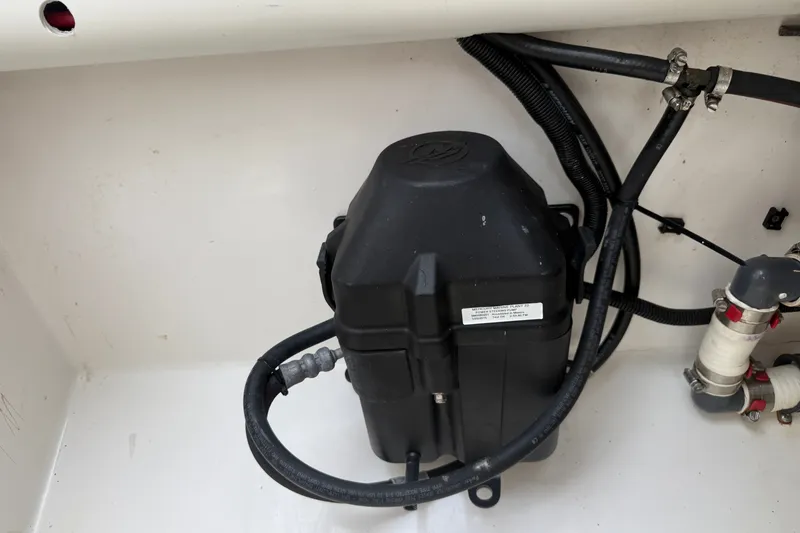 Slide: The Image of Engine compartment of a 2015 Belzona 32 Center Console boat, featuring hoses and components. - 26