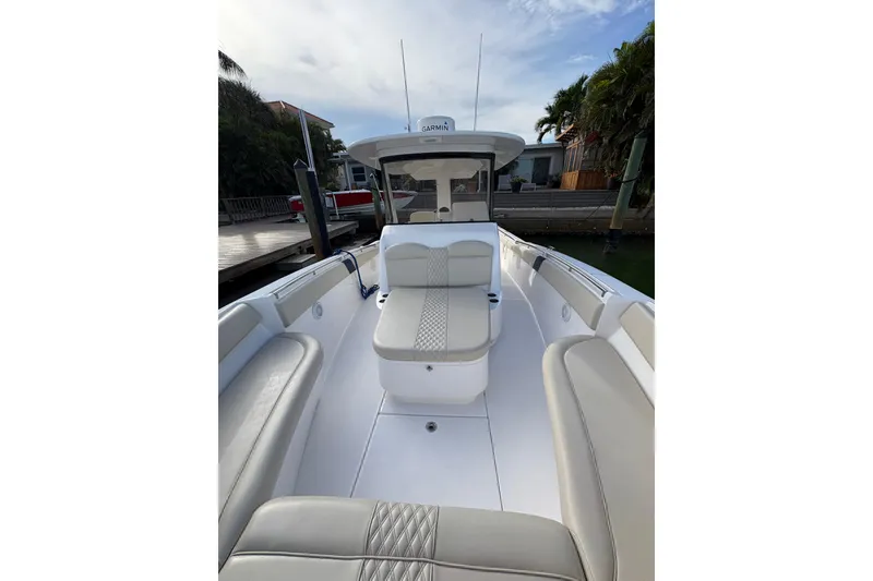 Slide: The Image of 2015 Belzona 32 Cuddy boat interior with cushioned seating and sleek design. - 6