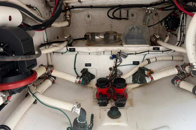 Slide: The Image of 2015 Belzona 32 Center Console engine compartment with hoses and wiring. - 25