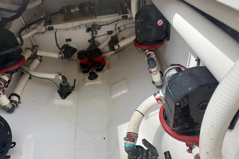 Slide: The Image of Interior view of 2015 Belzona 32 Center Console boat's engine compartment with visible piping and components. - 24