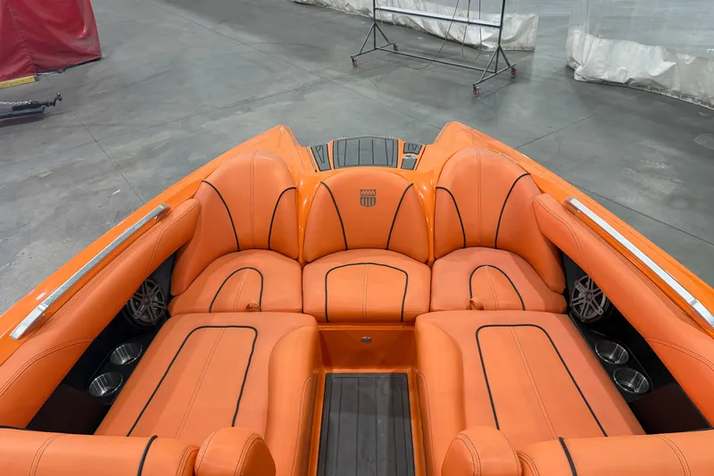 Slide: The Image of 2013 MasterCraft XStar boat with vibrant orange seating and sleek interior design. - 11