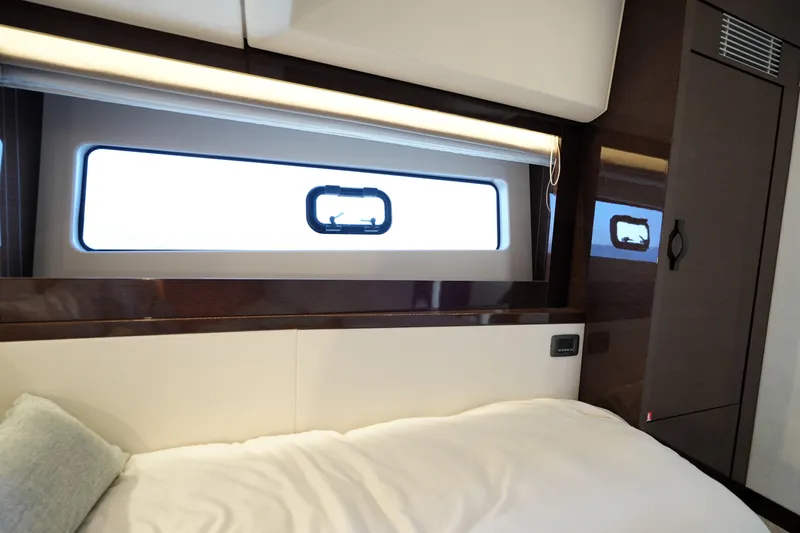 Slide: The Image of Luxurious interior of 2023 Prestige 590 yacht, featuring elegant wood finishes and modern design. - 76