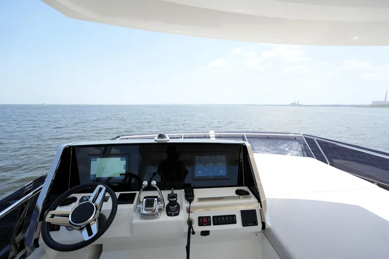 Slide: The Image of Cockpit view of 2023 Prestige 590 yacht, featuring modern navigation controls and open sea horizon. - 38