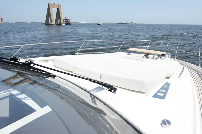 Slide: The Image of Prestige 590 yacht deck with ocean view, 2023 model, featuring sleek design and spacious layout. - 26