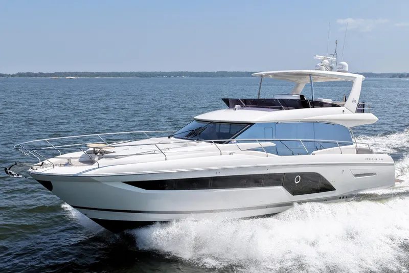 Slide: The Image of 2023 Prestige 590 yacht cruising on open water, showcasing sleek design and luxury features. - 13