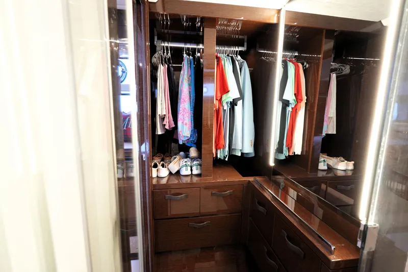 Slide: The Image of Luxurious wooden closet with clothes and shoes, inside a 2023 Prestige 590 model. - 85
