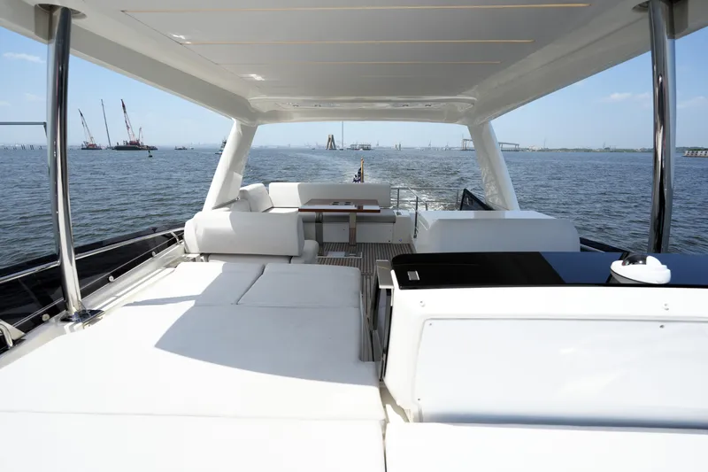 Slide: The Image of Luxurious 2023 Prestige 590 yacht interior with ocean view and elegant seating area. - 35