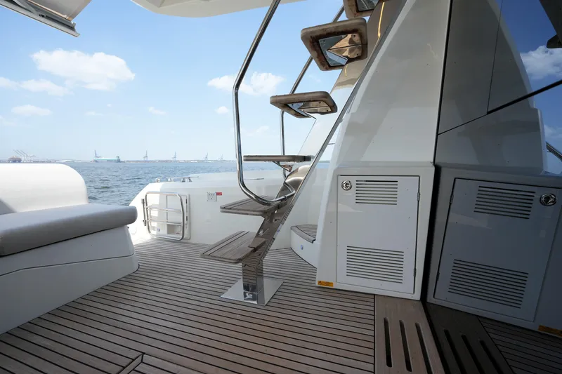 Slide: The Image of Luxury yacht deck with wooden flooring and stairs, Prestige 590, 2023 model, ocean view. - 24