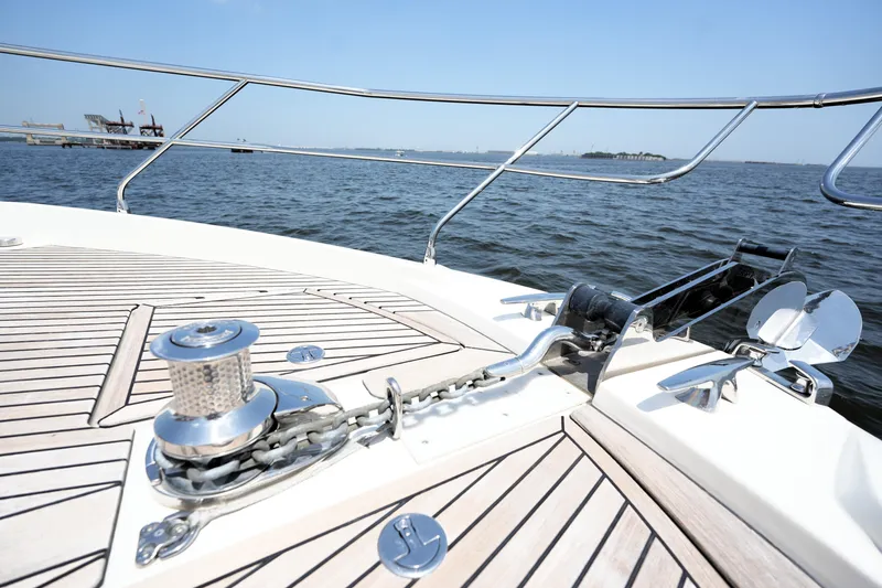 Slide: The Image of Bow of 2023 Prestige 590 yacht with anchor and ocean view. - 29