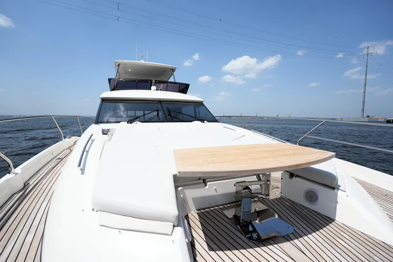 Slide: The Image of Luxury 2023 Prestige 590 yacht on open water, showcasing sleek design and spacious deck. - 27