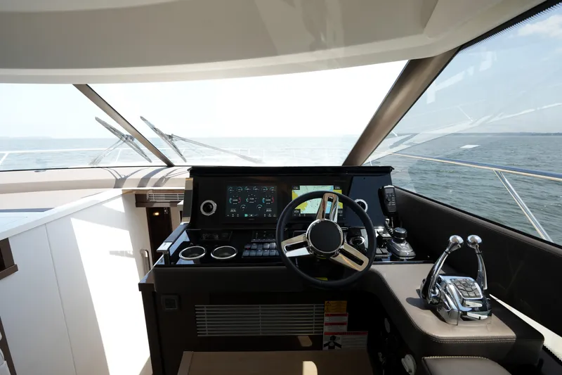 Slide: The Image of Luxurious 2023 Prestige 590 yacht cockpit with modern controls and panoramic sea view. - 62