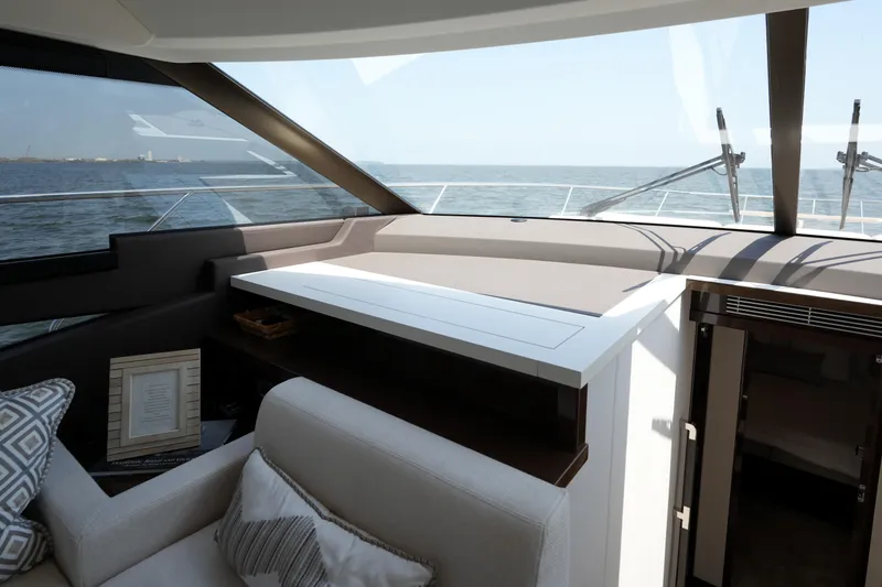 Slide: The Image of Luxurious interior of 2023 Prestige 590 yacht with ocean view through large windows. - 59